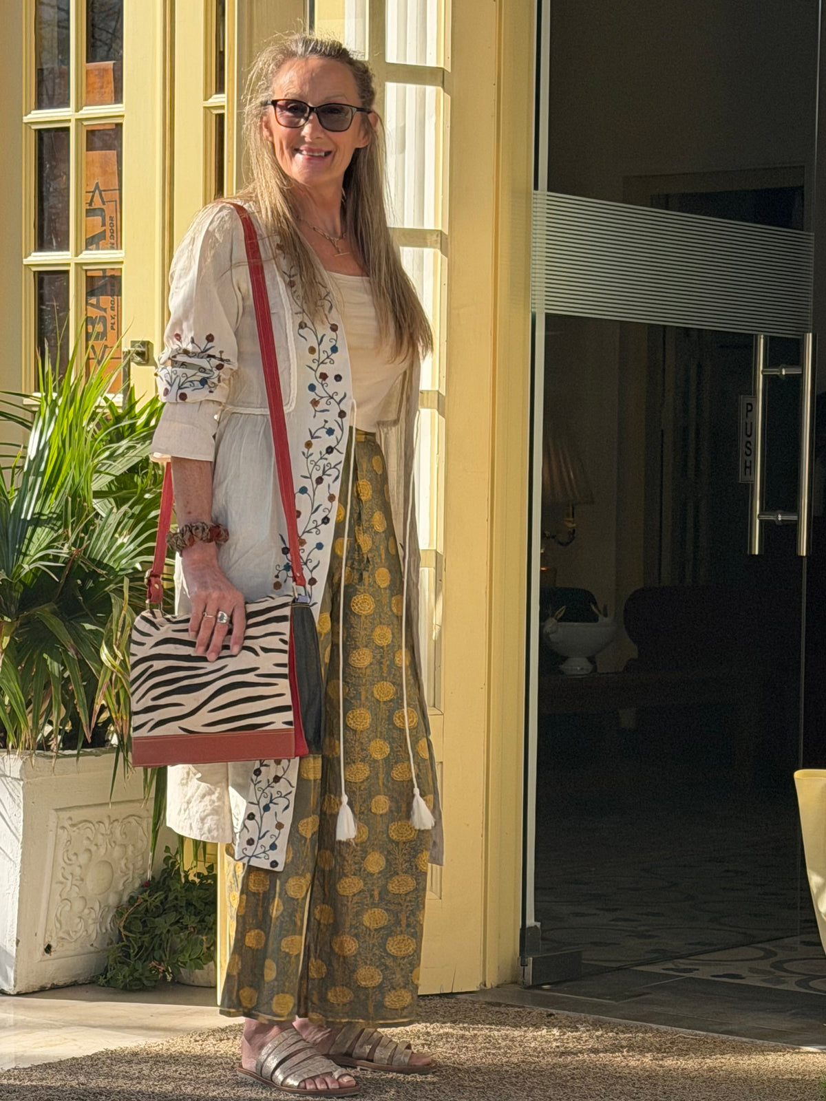 Kay, March 2026 on business for JayKayBoutique carrying her latest design Recycled Coloured Leather messenger bag