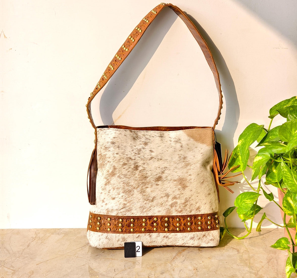 Cowhide Shoulder Bag – Western Leather Handbag with Studded Detail, Handmade Leather Strap & Tassels - JayKayBoutiqueOnline